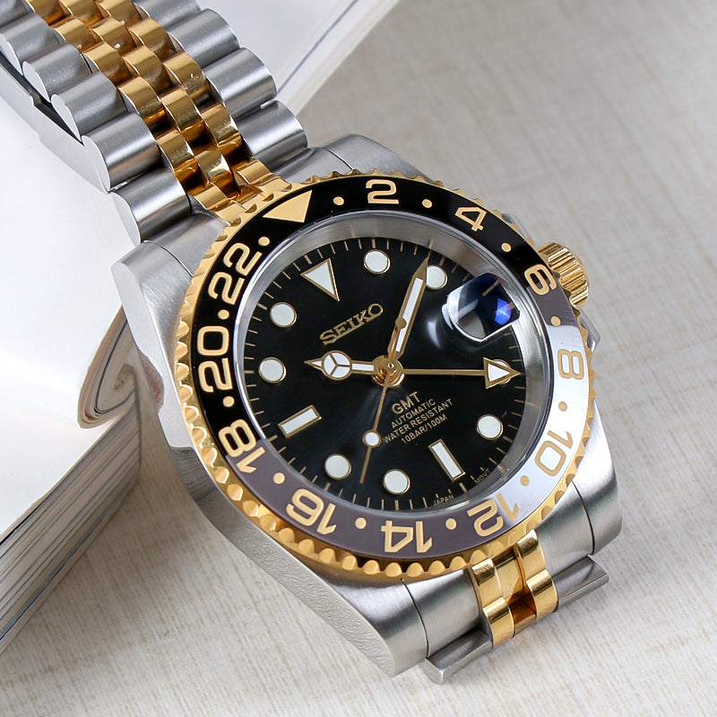 Traveler GMT Automático – Black Gold Jubilee Steel NH34