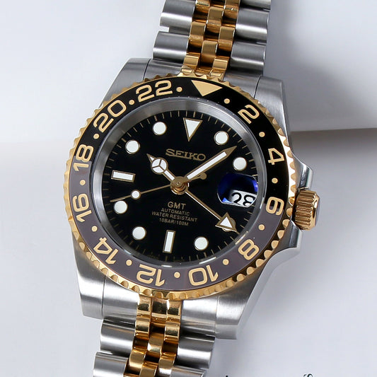 Traveler GMT Automático – Black Gold Jubilee Steel NH34