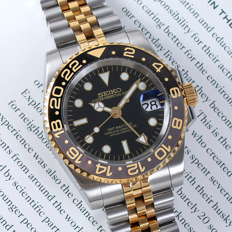 Traveler GMT Automático – Black Gold Steel Jubilee NH34